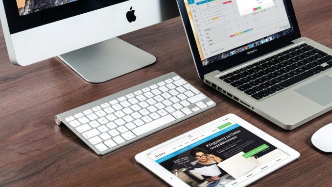 A Mac, macbook and tablet on a desk