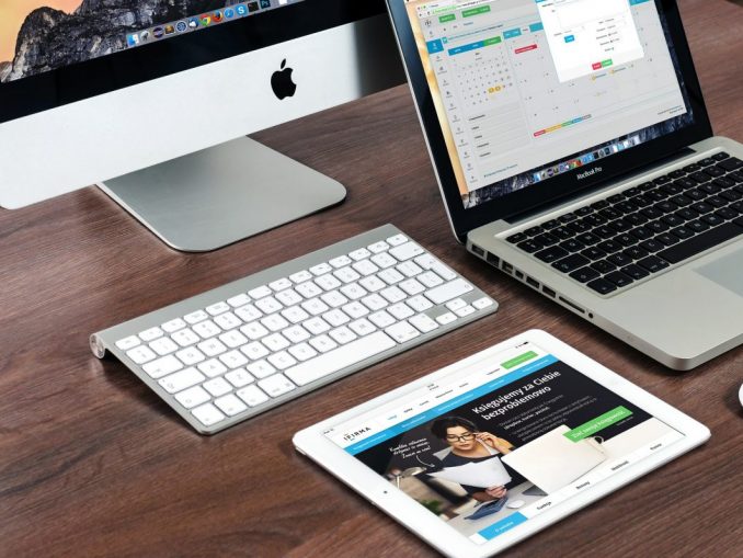 A Mac, macbook and tablet on a desk